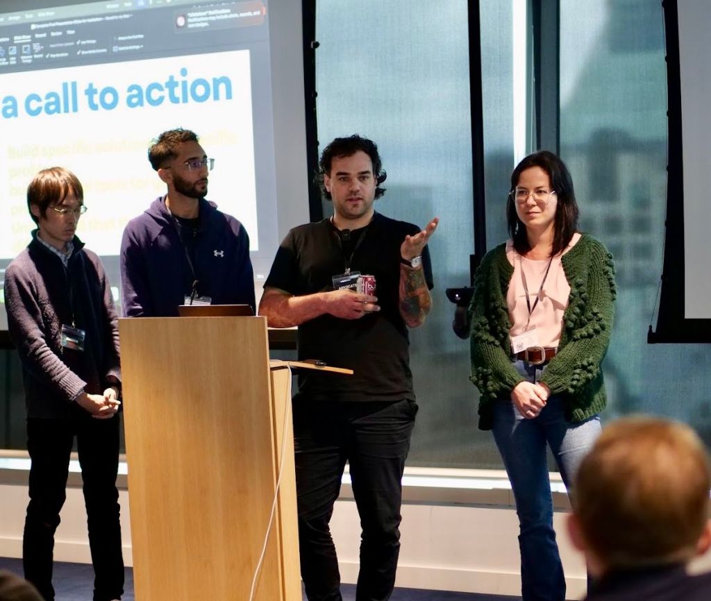Lachlan Deyong and Mariia Morello of Law for Humans winning an award at the Access to Justice Hackathon in 2025